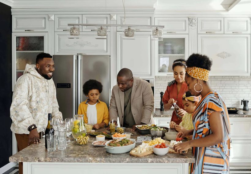 Family preparing a feast around the kitchen island
