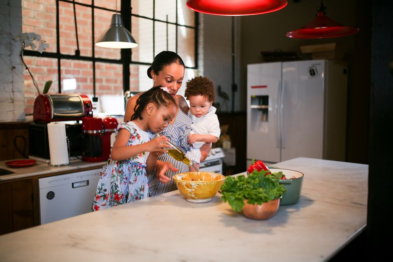 Mother and children making a meal in their kitchen