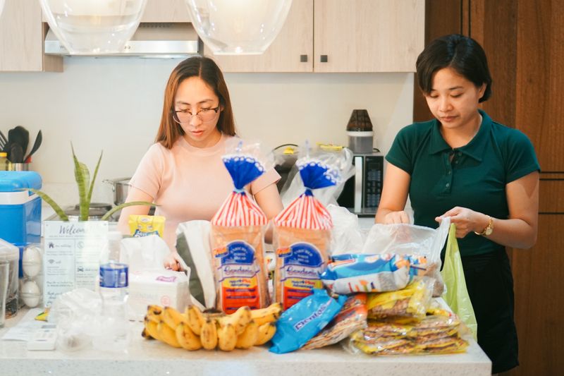 Two people unpacking groceries at the kitchen counter